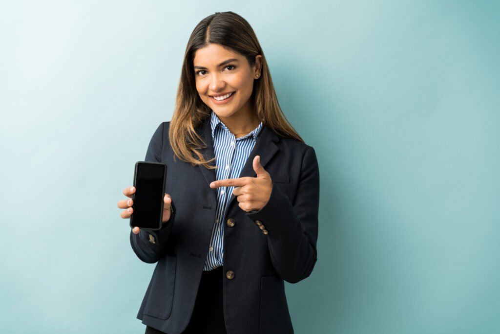 girl_pointing_towards_mobile_smiling